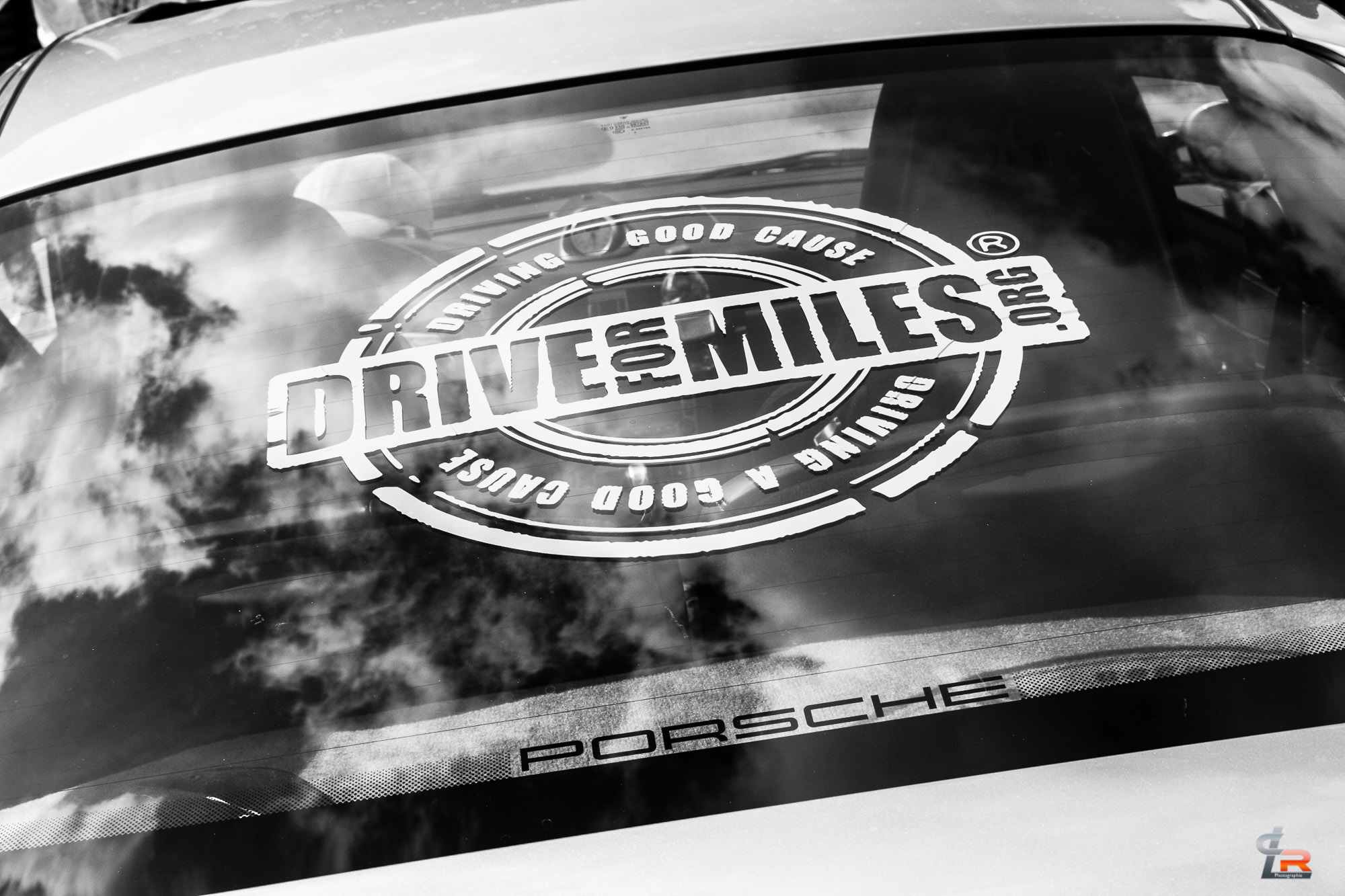 Drive for Miles logo on a Porsche rear window (black and white)